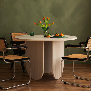 Modern Dining Room with Elegant Table, Stylish Chairs, and Fresh Blooms Amidst a Serene Green Wall