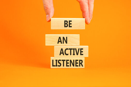 Be an active listener words symbol. Concept words Be an active listener on beautiful wooden blocks. Beautiful orange background. Businessman hand. Business be an active listener concept. Copy space.