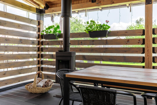 Covered Terrace Interior with Dining Table and Wood Stove
