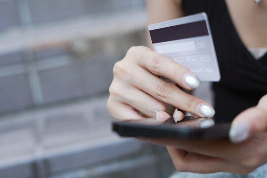 credit card.  Woman making an online purchase using a mobile phone. and digital shopping e-banking. concept  e-commerce make purchase or booking reservation. internet investment on mobile app.