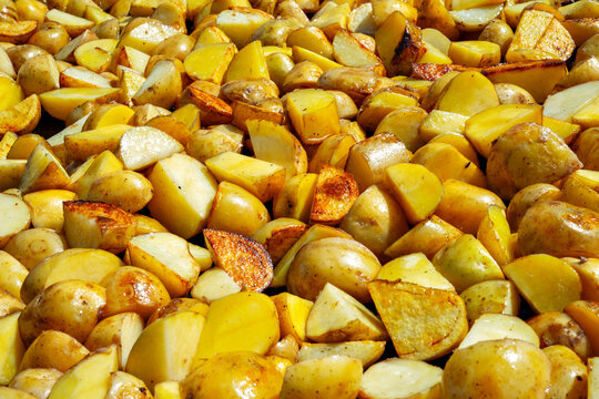 Freshly cut potatoes ready for roasting in a kitchen during the daytime