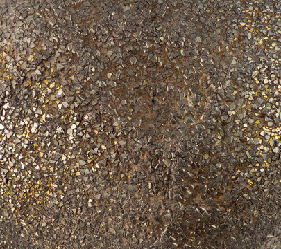 Crystal of pyrite found in a natural setting showing its shiny, metallic surface