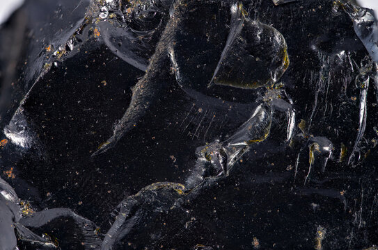 Black rock with shiny surface shows natural features in close up