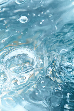 Abstract light blue bubbling water surface texture with ripples and splashes