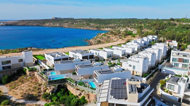 Aerial view of Konnos Bay hotels in Cyprus. Resort buildings, sandy beach and calm blue sea create a bright summer vacation landscape.