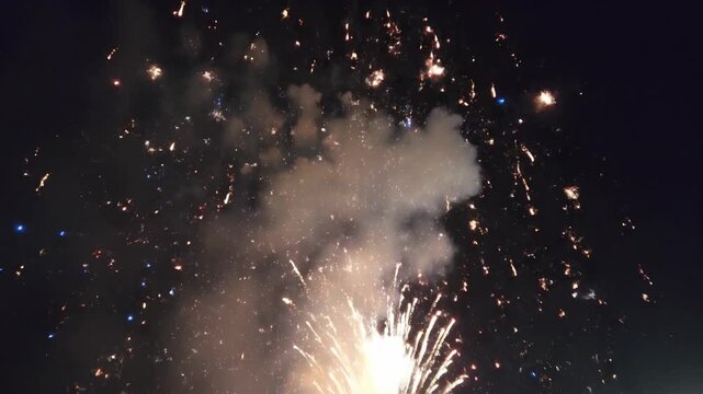 White firework explosion against black night sky.