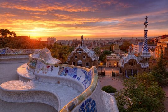 Barcelona park panorama at sunset with mosaic benches and city skyline