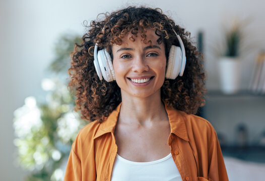 Beautiful woman with headphones looking at camera at home