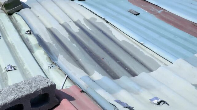 Stagnant Water on Deteriorated Corrugated Fiber Cement Roof Creating Mosquito Breeding and Public Health Risk Near Residential Homes, 60fps 4K Video