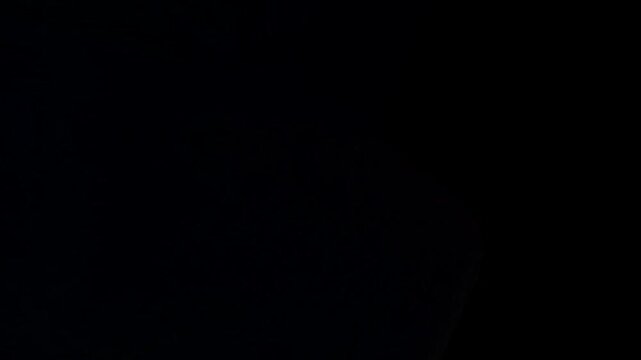 Abstract dark background with subtle diagonal texture and a small blue light