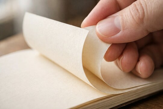 Macro Shot of Fingers Flipping Blank Paper Page