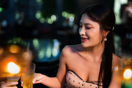 food and drink male friends are happy drinking beer and clinking glasses at a bar or pub.