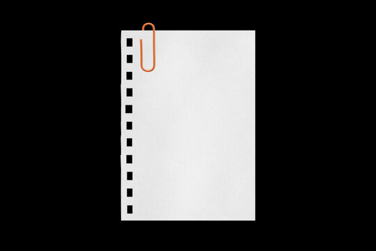 white sheet torn from a notebook on a black background with a colored paper clip