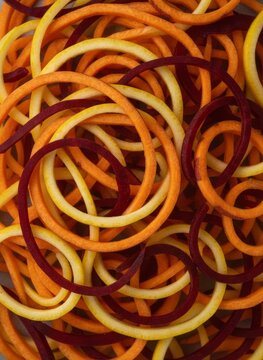 Spiralized Fresh Root Vegetables Background with Beetroot Sweet Potato and Squash Noodles
