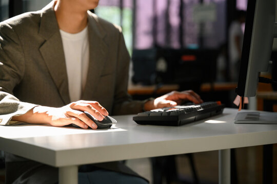 Cropped of Business Professional Working at Desktop Computer with Mouse and Keyboard in Modern Office