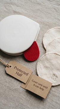 Symbolic Red Blood Drop on White Surface with 'Protected Half' Tag, Representing Blood Donation