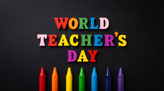 The phrase World Teachers Day spelled with colorful wooden letters, accompanied by a row of vibrant wax crayons, displayed on a black background for education.
