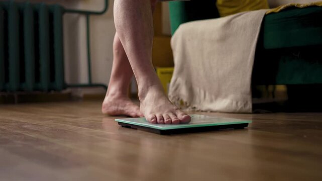 Person Stepping on Weight Scale in Cozy Living Room