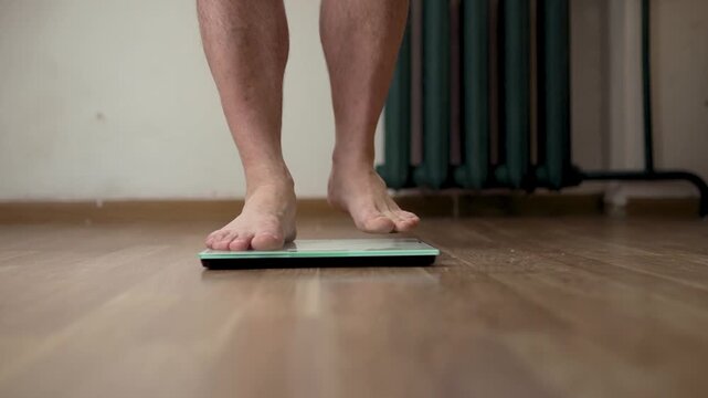 Wide Low Angle Shot of Person Using Weight Scale at Home