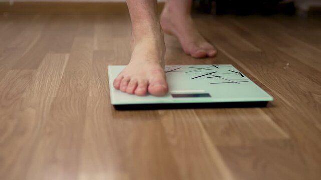 Top Angle View of Foot Stepping on Digital Scale