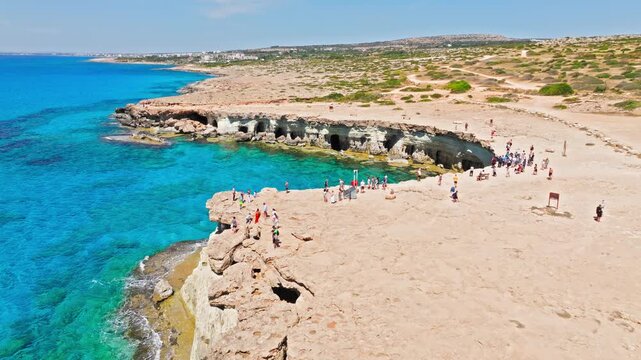 Drone view of Cape Cavo Greco headland in Cyprus. Dry rocky terrain, open sea and pale limestone cliffs create a peaceful rugged seascape.