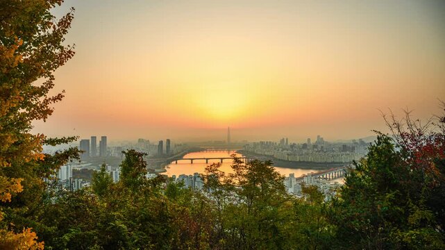 4K time-lapse video of a sunrise from Mount Maebongsan in autumn, central Seoul, the Han River, and the Lotte Tower in Seoul, South Korea.