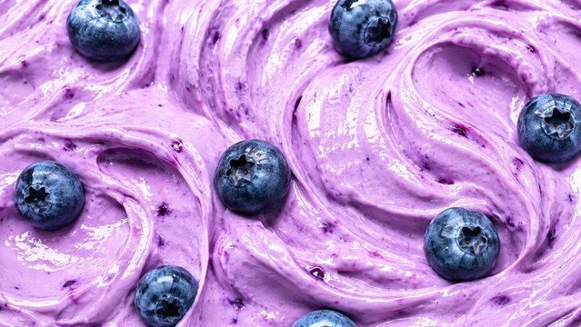 Creamy blueberry mousse with vivid purple swirls and fresh berries.