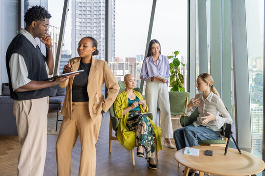 Group of People Discussing Ideas in Modern Office Space