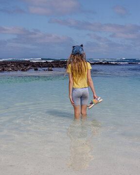 Girl looking into Galapagos tidal pools