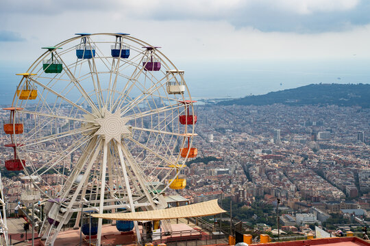 Epic vintage ferris wheel amusement park horizontal panorama cityscape sea view.
