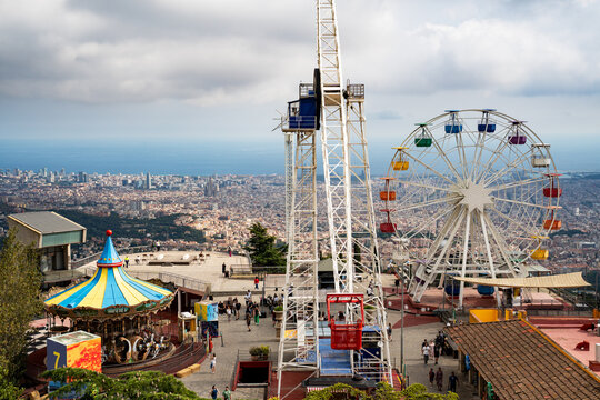 Epic vintage ferris wheel amusement park horizontal panorama cityscape sea view.
