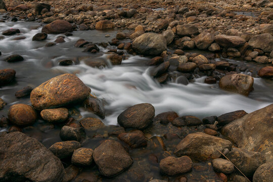 Jaldhaka River and stones at river bed, flowing through India, Bhutan, and Bangladesh. Originating from Kupup Lake in East Sikkim. Joldhaka river, Jhalong - Dooars , north bengal - West Bengal, India.