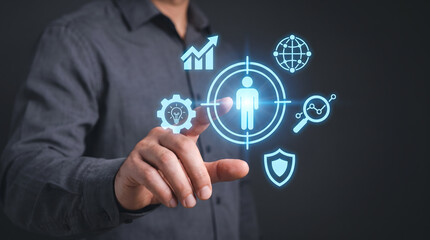 Obraz premium Target audience and customer relationship management: Businessman touching virtual human icon in target, Human resources and talent acquisition concept.