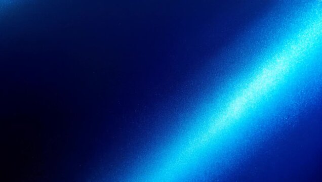 Textured surface illuminated by a diagonal beam of glowing blue light HD video texture glow dark abstract HD video