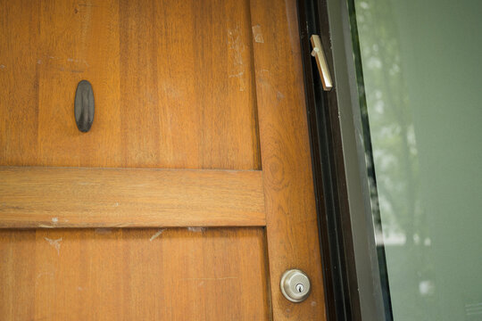 Wooden Entrance Door with Mezuzah on the Doorpost of a Jewish Home
