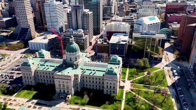 drone footage capturing the heart of Indianapolis, Indiana, showcasing its iconic skyline, contemporary architecture, commercial district, and expansive city layout from a breathtaking perspective abo