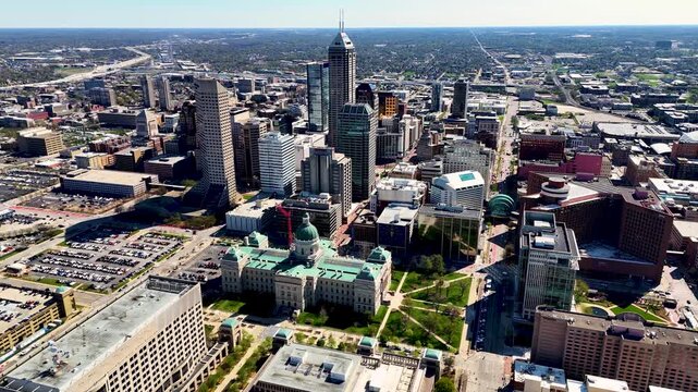 drone footage capturing the heart of Indianapolis, Indiana, showcasing its iconic skyline, contemporary architecture, commercial district, and expansive city layout from a breathtaking perspective abo