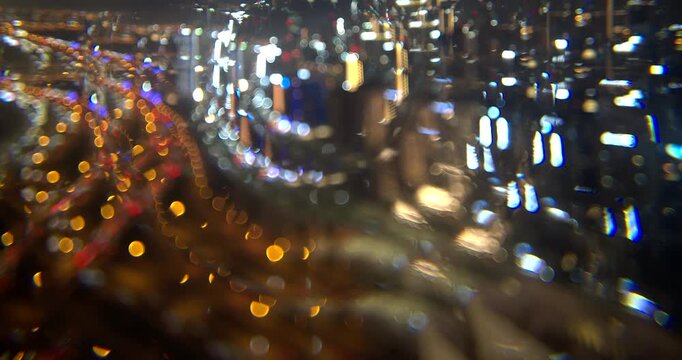 Kaleidoscope effect over Dubai city lights at night, glass prism filter on the lens repeats the towers and bokeh lights into a symmetric pattern, in camera effect, timelapse