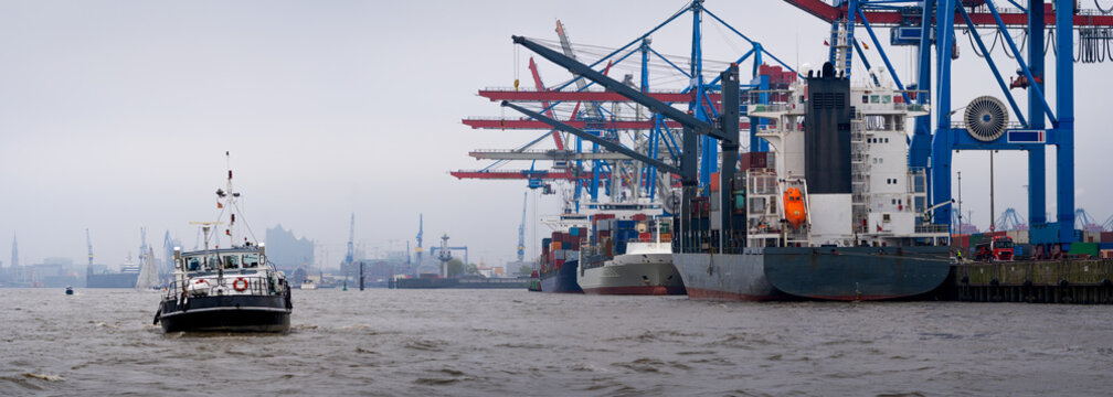 Tugboat on Elbe River by Container Terminal Cranes, Hamburg Germany