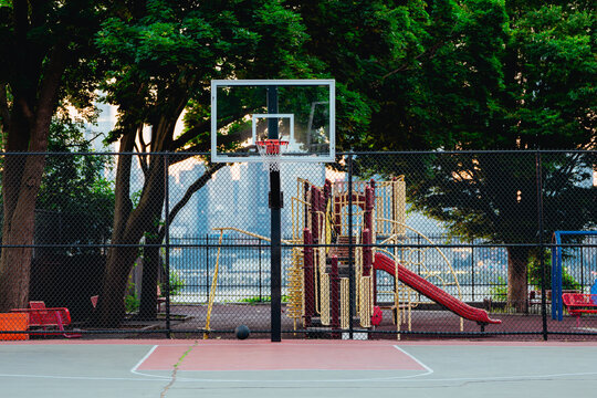 Empty Basketball Court and Playground in a Waterfront Urban Park