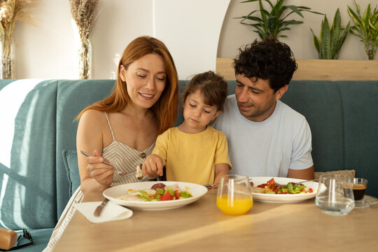 Family enjoying breakfast together at restaurant