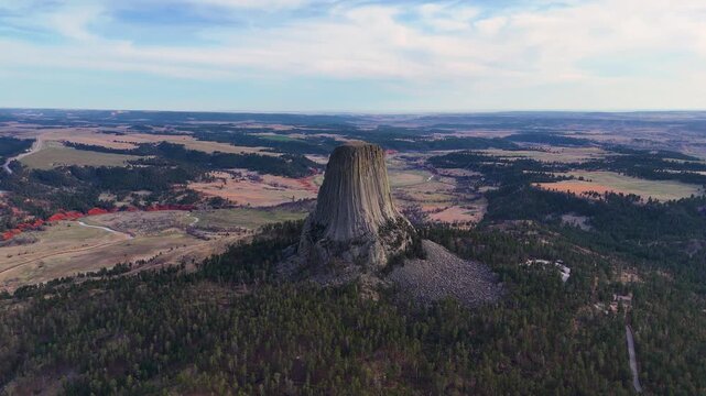 Beautiful aerial footage featuring Devils Tower in Wyoming, highlighting the massive natural rock formation, untouched wilderness, and breathtaking scenery of one of America's most recognizable nation