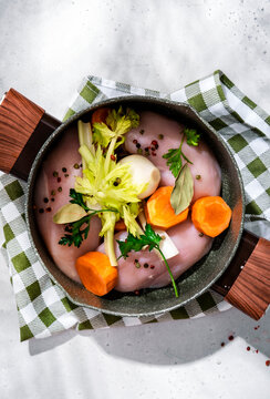 Raw chicken breast broth ingredients. Natural home cook meal concept with fresh roots and spices.