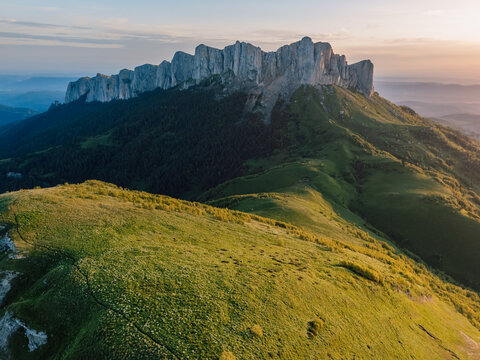 Drone view of Bolshoy Tkhach mountain in Caucasus with sunset or sunrise