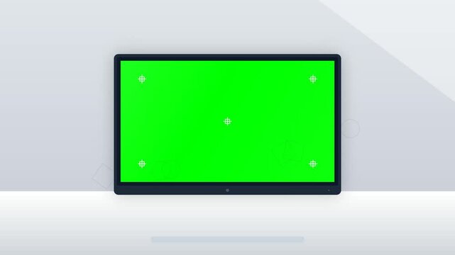 Modern electronic display with a bright green screen for compositing software sits in a clean room with soft diffuse lighting.