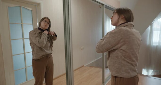 Girl Doing Hair Make Hairstyle Looking in the Mirror. 4K 10-bit