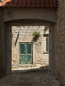Old wooden door in a traditional stone house, historic architecture and charming European old town atmosphere