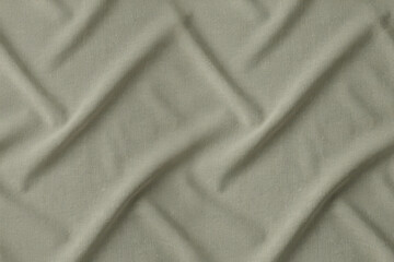Obraz premium Close up view of sage green fabric with a diagonal quilted pattern creating soft shadows and highlights on the textured textile surface