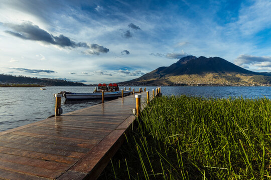 Beautiful San Pablo Lake in Otavalo, Ecuador with the majestic Imbabura Volcano in the background under a blue sky. Rural landscape of the Ecuadorian Andes