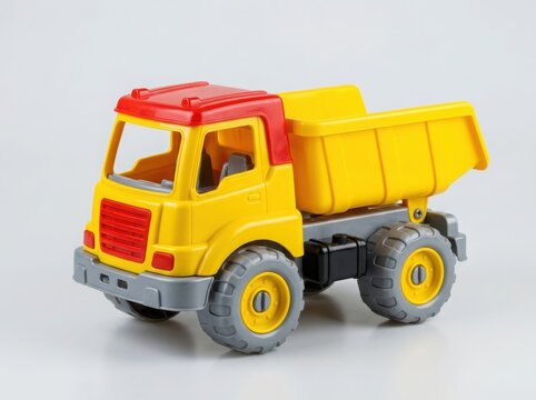 Bright yellow and red toy dump truck for kids playing construction and transport games